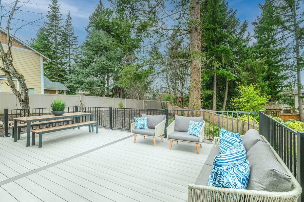 Custom cedar deck with a pergola and built-in seating in a landscaped backyard